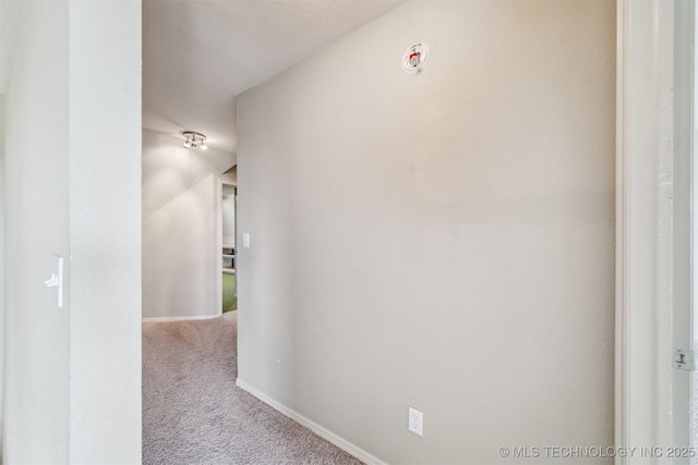 hall with carpet flooring and baseboards