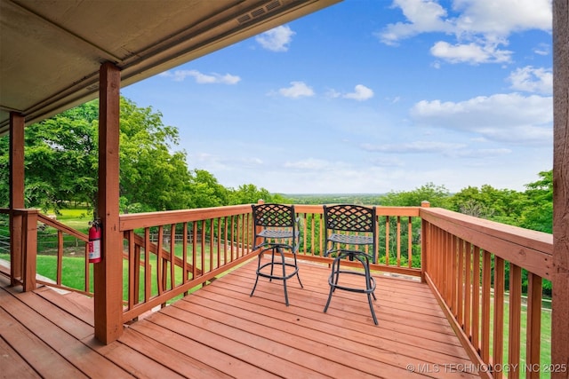 wooden terrace featuring visible vents