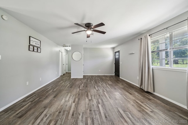 9553 W 71st St S, Tulsa, OK 74131 - unfurnished living room with baseboards, ceiling fan, and wood finished floors