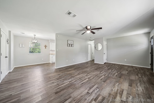 9553 W 71st St S, Tulsa, OK 74131 - unfurnished living room with baseboards, ceiling fan with notable chandelier, dark wood-style floors, and visible vents