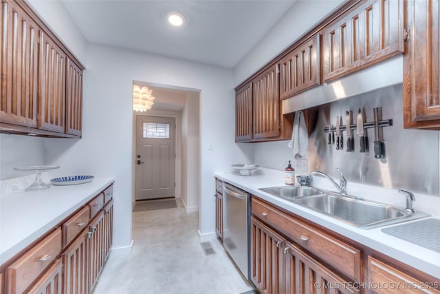 kitchen featuring light countertops, a sink, concrete flooring, baseboards, and dishwasher