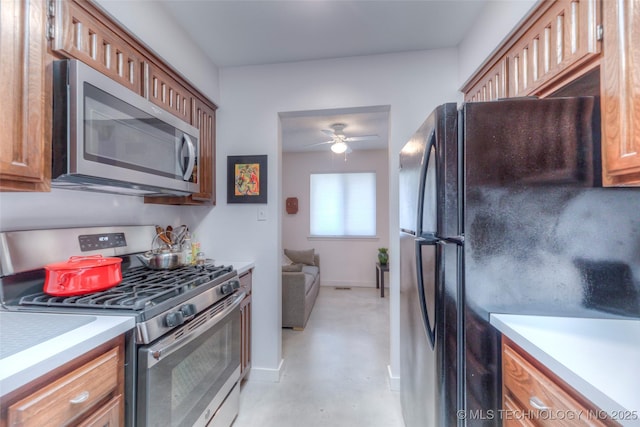 kitchen with light countertops, stainless steel appliances, and brown cabinetry