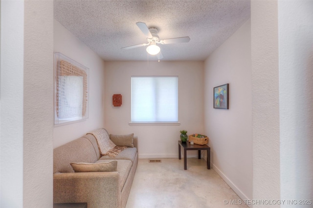 living area with a textured ceiling, visible vents, ceiling fan, and carpet floors