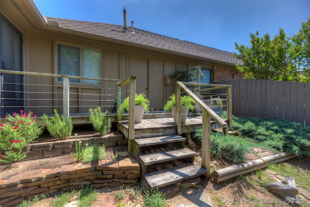 wooden terrace featuring fence