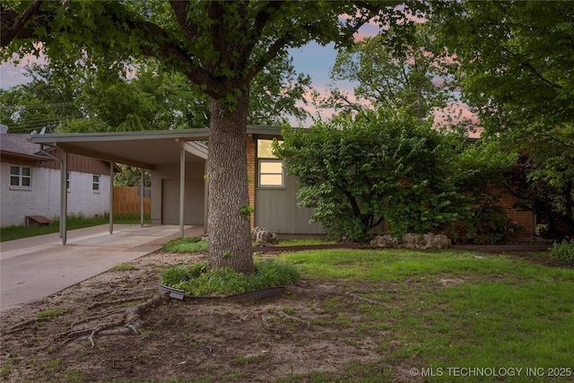 mid-century inspired home featuring driveway, fence, and a lawn