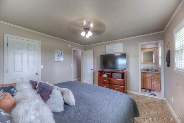 bedroom featuring ensuite bathroom, carpet, crown molding, ceiling fan, and baseboards