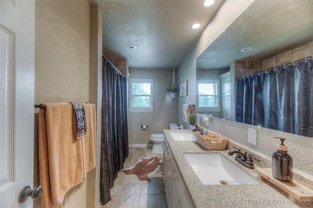 bathroom featuring toilet, a shower with shower curtain, vanity, and recessed lighting
