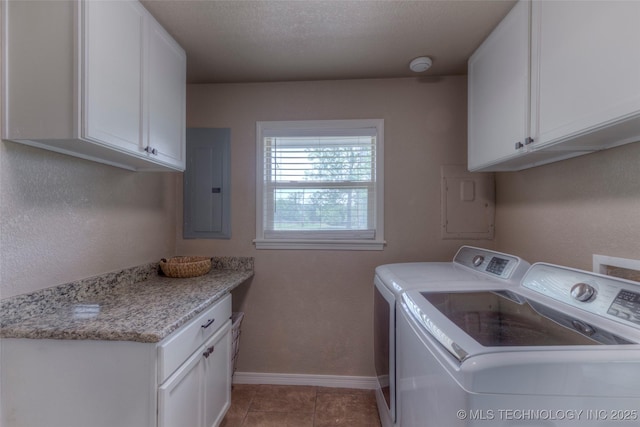 clothes washing area featuring baseboards, washer and dryer, light tile patterned flooring, electric panel, and cabinet space