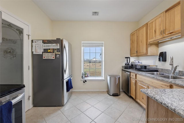 16550 S Elwood Ave, Glenpool, OK 74033 - kitchen featuring appliances with stainless steel finishes, visible vents, light tile patterned floors, and a sink