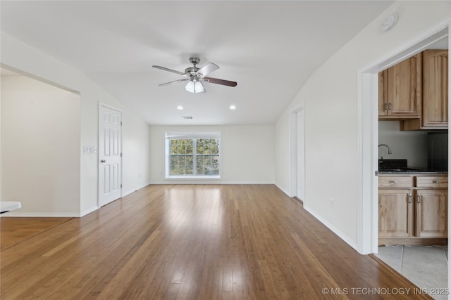 16550 S Elwood Ave, Glenpool, OK 74033 - unfurnished living room with baseboards, ceiling fan, light wood-style floors, vaulted ceiling, and recessed lighting