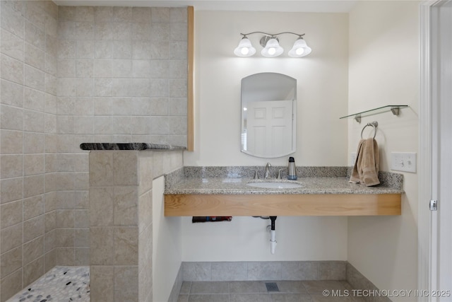 16550 S Elwood Ave, Glenpool, OK 74033 - full bathroom with a tile shower and a sink