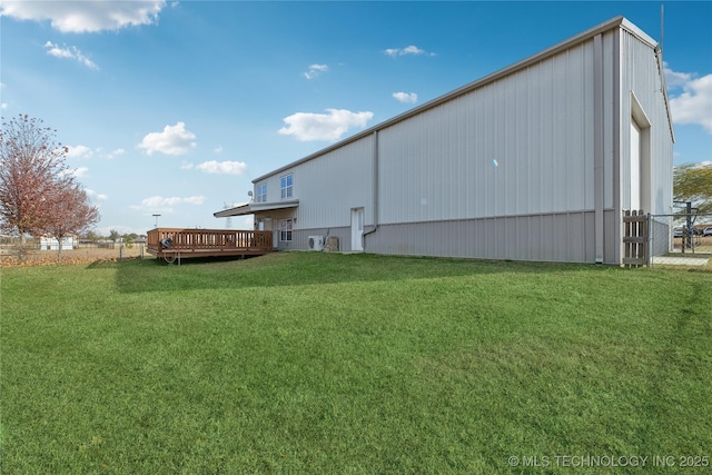 16550 S Elwood Ave, Glenpool, OK 74033 - back of house featuring a deck, an outdoor structure, fence, a pole building, and a lawn