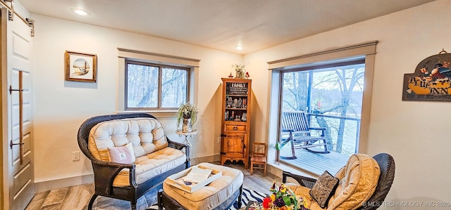 living area featuring baseboards, recessed lighting, and wood finished floors