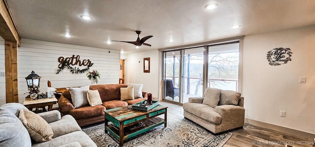 living area with baseboards, recessed lighting, a ceiling fan, and wood finished floors