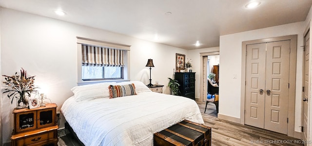 bedroom with baseboards, light wood-style floors, and recessed lighting