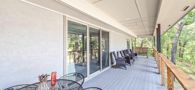wooden terrace featuring an outdoor living space and outdoor dining area