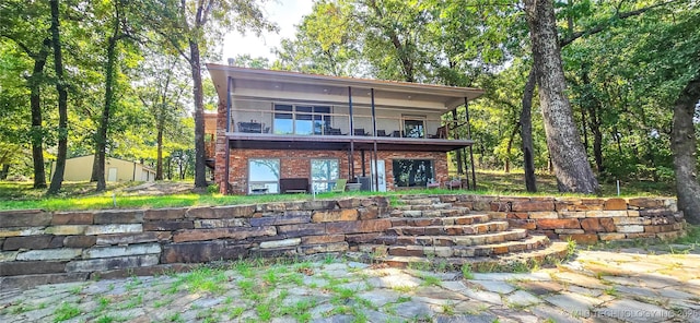back of house featuring a balcony