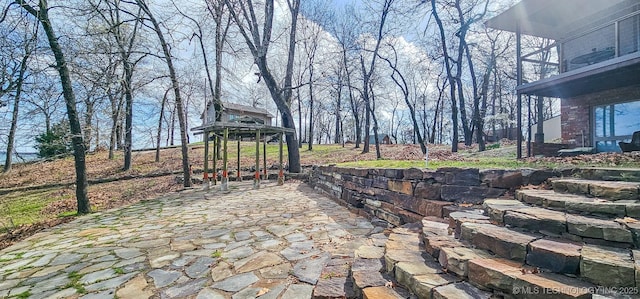view of patio / terrace featuring a gazebo and a balcony
