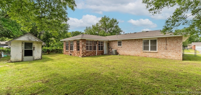 1117 W Chambers Ct, Claremore, OK 74017 - rear view of house featuring a storage shed, a yard, fence, and central AC
