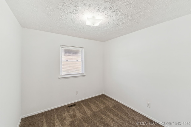 1117 W Chambers Ct, Claremore, OK 74017 - unfurnished room featuring baseboards, dark carpet, visible vents, and a textured ceiling
