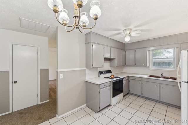1117 W Chambers Ct, Claremore, OK 74017 - kitchen featuring light countertops, a sink, visible vents, white appliances, and gray cabinetry