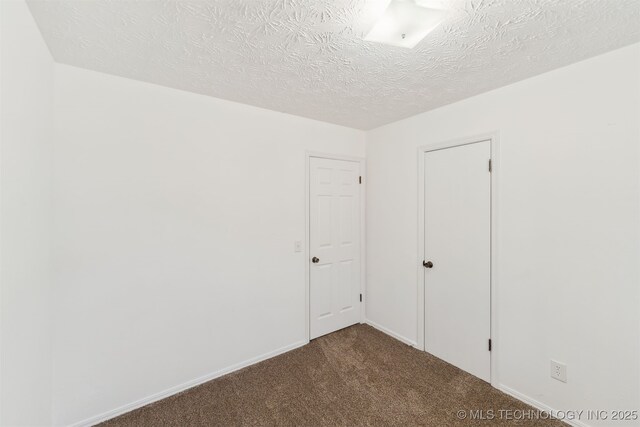1117 W Chambers Ct, Claremore, OK 74017 - empty room featuring dark carpet and a textured ceiling