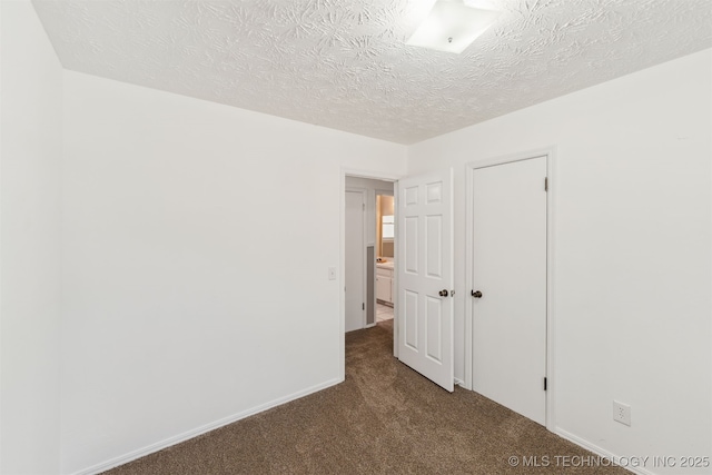 1117 W Chambers Ct, Claremore, OK 74017 - unfurnished bedroom featuring a textured ceiling, carpet floors, and baseboards