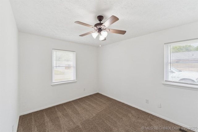 1117 W Chambers Ct, Claremore, OK 74017 - empty room featuring a ceiling fan, baseboards, and dark colored carpet