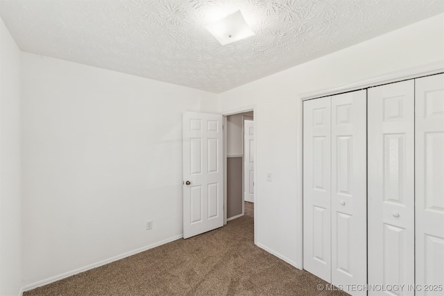 1117 W Chambers Ct, Claremore, OK 74017 - unfurnished bedroom featuring carpet flooring, a closet, a textured ceiling, and baseboards