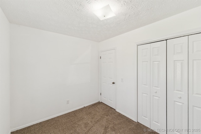 1117 W Chambers Ct, Claremore, OK 74017 - unfurnished bedroom with a closet, a textured ceiling, baseboards, and carpet floors