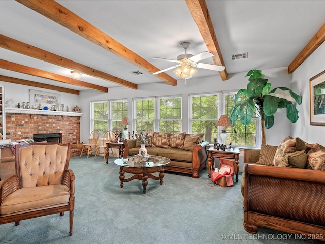 living area featuring ceiling fan, carpet, beamed ceiling, and visible vents