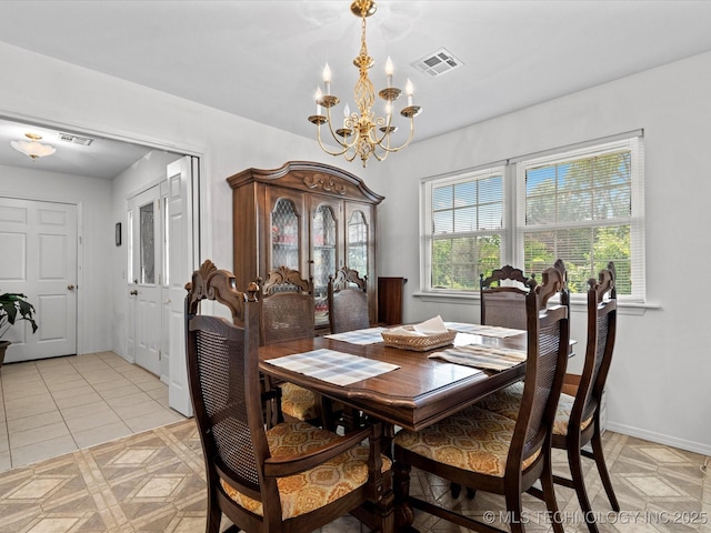 dining area featuring a chandelier, light tile patterned flooring, baseboards, and visible vents