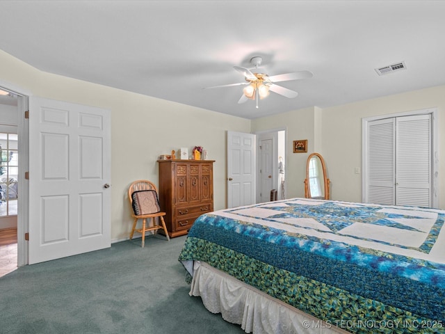 carpeted bedroom featuring a closet, a ceiling fan, and visible vents