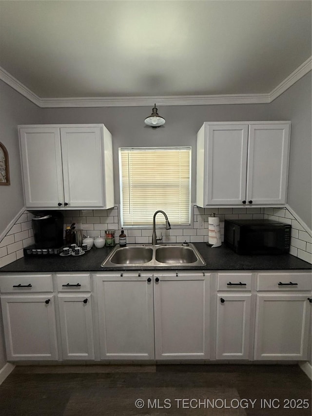905 Leahy Ave, Pawhuska, OK 74056 - kitchen featuring white cabinets, dark countertops, black microwave, and a sink