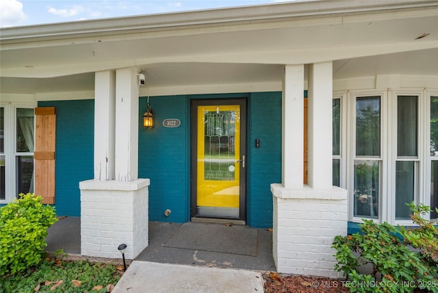 1022 W E St, Jenks, OK 74037 - view of exterior entry with a porch and brick siding