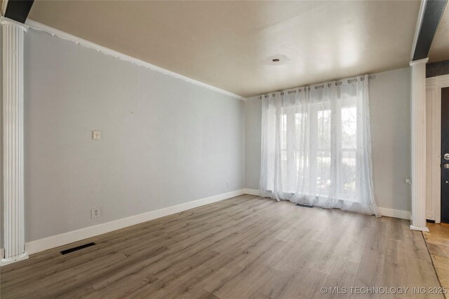1022 W E St, Jenks, OK 74037 - unfurnished room with wood finished floors, decorative columns, and baseboards