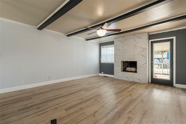 1022 W E St, Jenks, OK 74037 - unfurnished living room featuring beam ceiling, ceiling fan, baseboards, wood finished floors, and a premium fireplace
