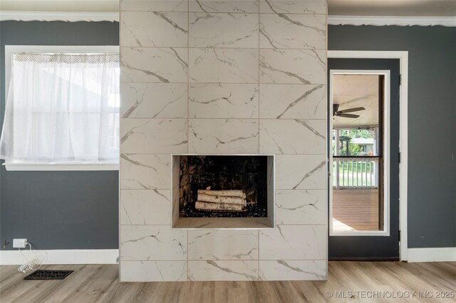 1022 W E St, Jenks, OK 74037 - detailed view of wood finished floors, baseboards, ornamental molding, and a high end fireplace