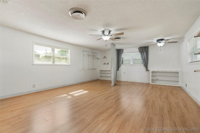 1022 W E St, Jenks, OK 74037 - spare room with a ceiling fan, light wood-type flooring, a textured ceiling, and baseboards