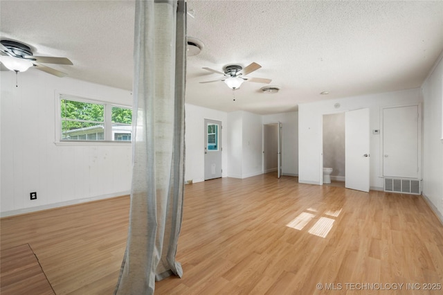 1022 W E St, Jenks, OK 74037 - spare room featuring ceiling fan, a textured ceiling, light wood-type flooring, and baseboards