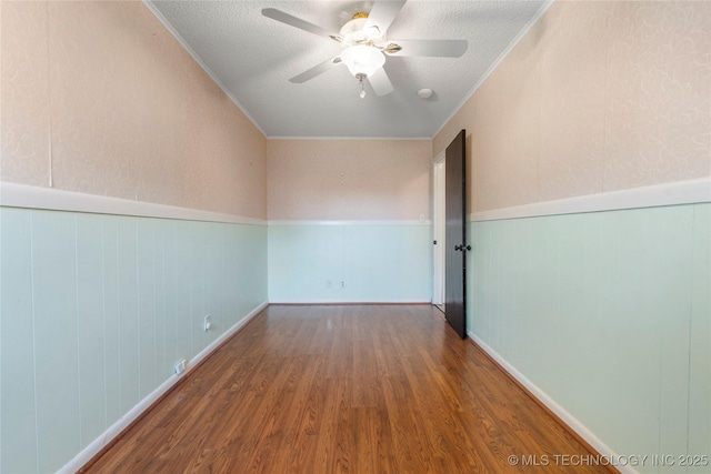 1022 W E St, Jenks, OK 74037 - unfurnished room with wood finished floors, a textured ceiling, a wainscoted wall, a ceiling fan, and crown molding