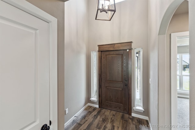 5113 S Walnut Creek Dr, Sand Springs, OK 74063 - entrance foyer with arched walkways, dark wood-type flooring, a chandelier, and baseboards