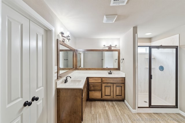 5113 S Walnut Creek Dr, Sand Springs, OK 74063 - full bath featuring a marble finish shower, double vanity, wood finished floors, and baseboards