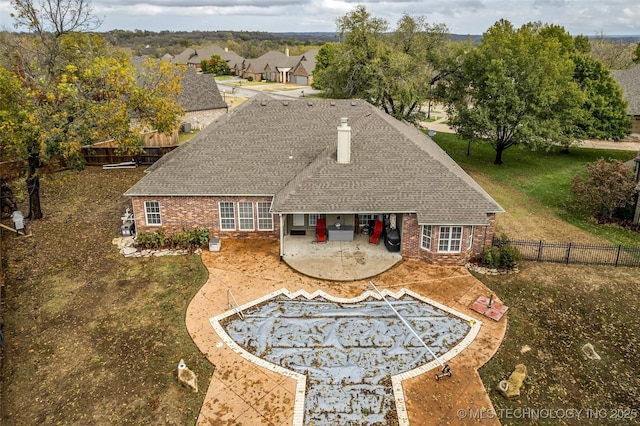 2501 Forest Ridge Parkway, Claremore, OK 74017 - rear view of house with a patio, brick siding, a fenced backyard, and a chimney