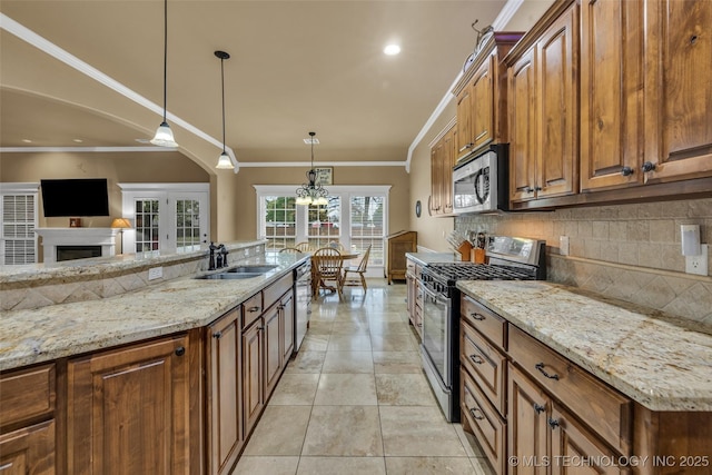 2501 Forest Ridge Parkway, Claremore, OK 74017 - kitchen with appliances with stainless steel finishes, a sink, backsplash, light stone countertops, and a fireplace