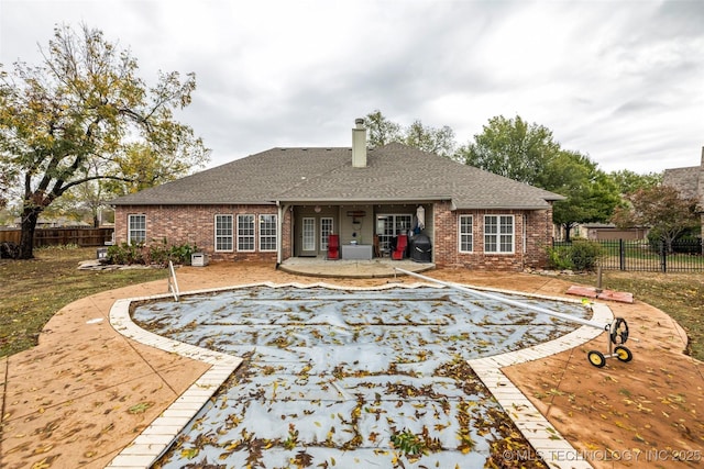 2501 Forest Ridge Parkway, Claremore, OK 74017 - back of house with brick siding, roof with shingles, and a patio area