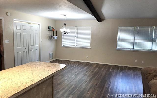 1607 Kay, Durant, OK 74701 - dining room with beam ceiling, a notable chandelier, dark wood-type flooring, baseboards, and visible vents