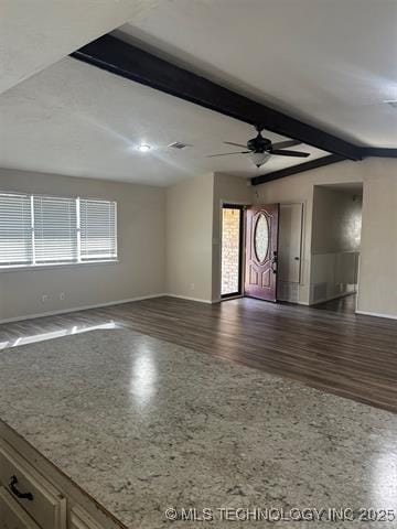 1607 Kay, Durant, OK 74701 - unfurnished living room with dark wood finished floors, plenty of natural light, baseboards, and a ceiling fan