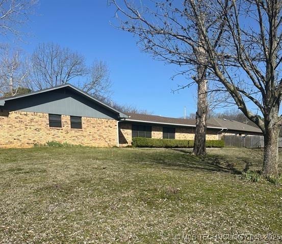 1607 Kay, Durant, OK 74701 - exterior space with brick siding and a lawn