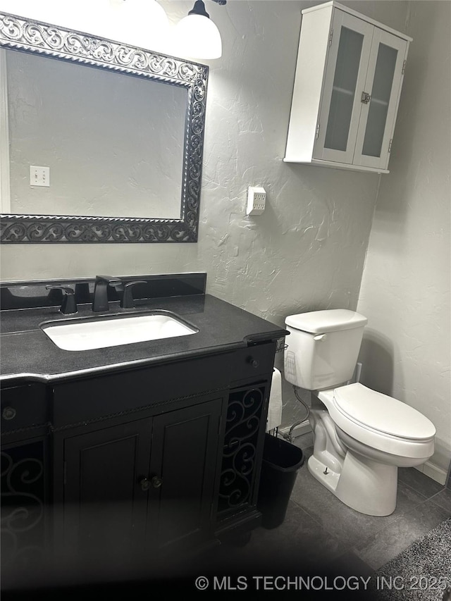 1607 Kay, Durant, OK 74701 - half bath with a textured wall, toilet, and vanity